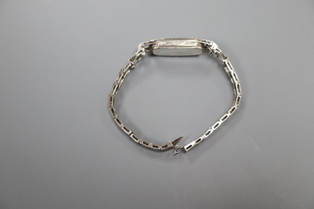 A ladys mid 20th century white metal (tests as platinum) and diamond set cocktail wrist watch, on diamond set bracelet, 16.5cm,